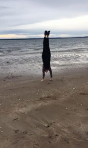 Ally doing a handstand on the beach