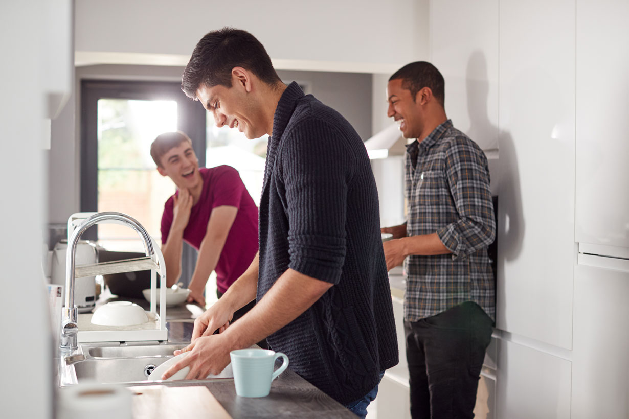 Male flatmates in their kitchen