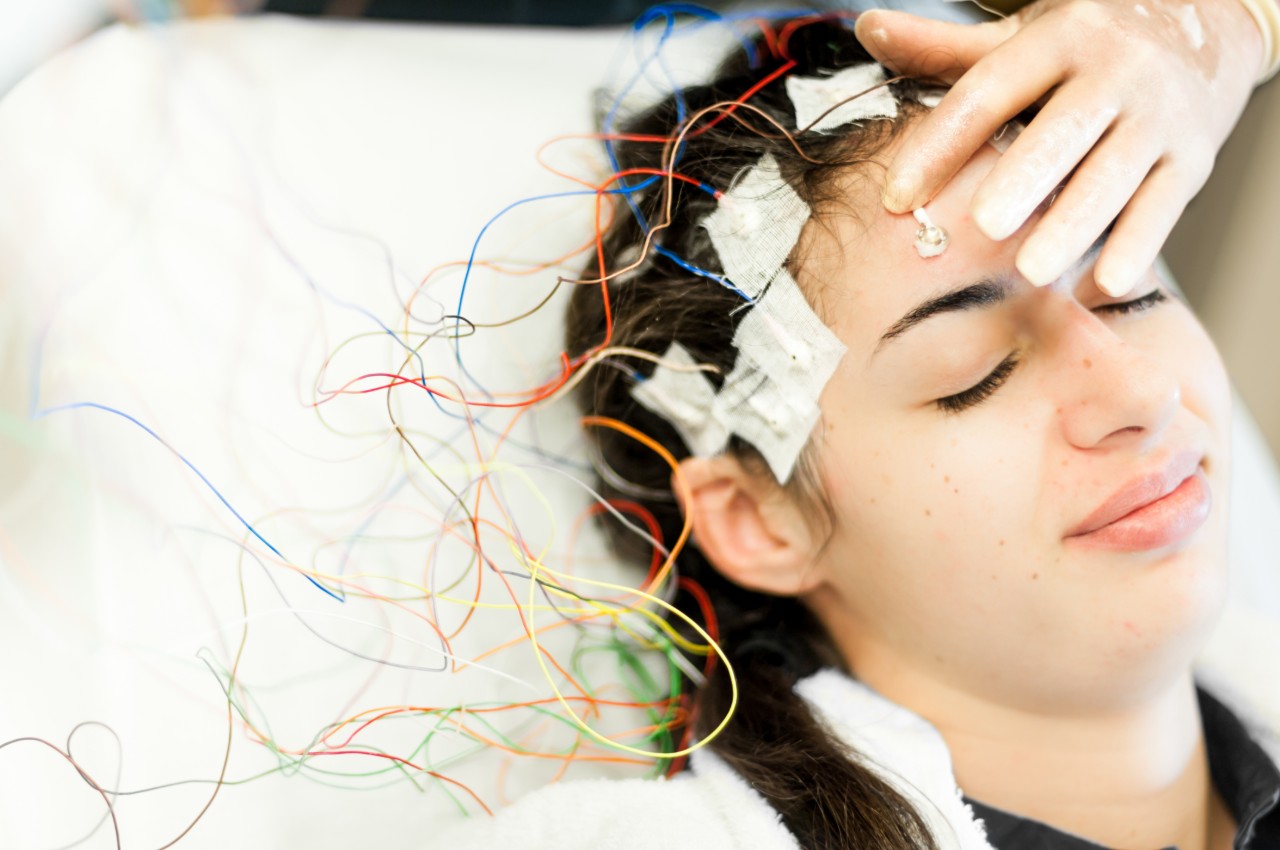 Young woman with electrodes stuck to her head
