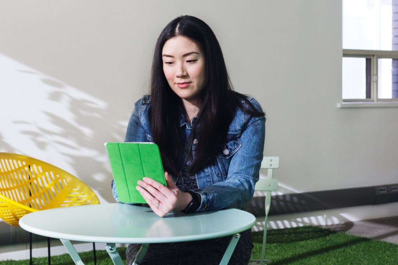 Young woman reading on a tablet