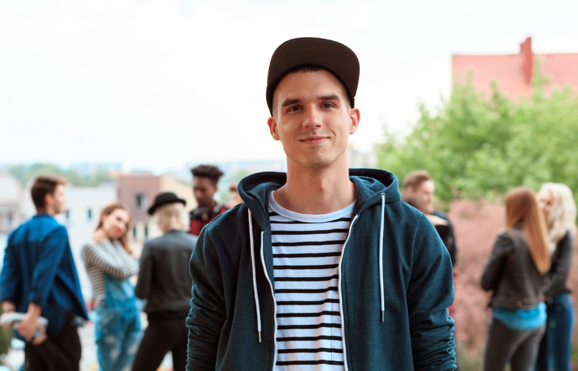 Man in a cap with his friends in the background