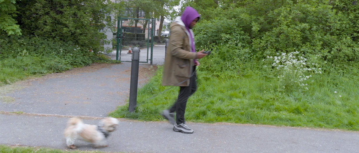 Derrick walking in the park with his dog